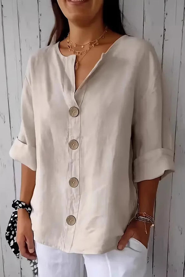Solid color, loosely buttoned V-neck top