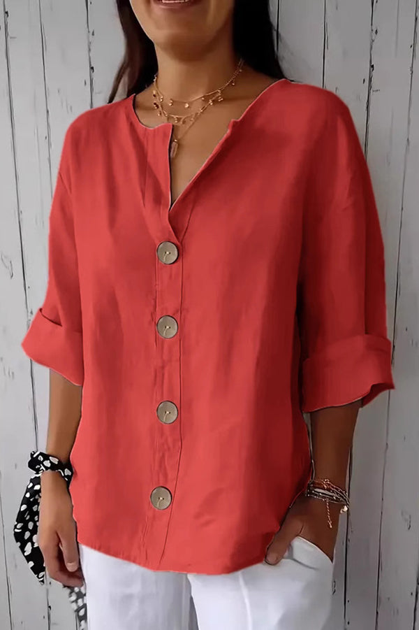 Solid color, loosely buttoned V-neck top